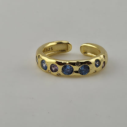 Adjustable open band zircon ring shown on ring mandrel