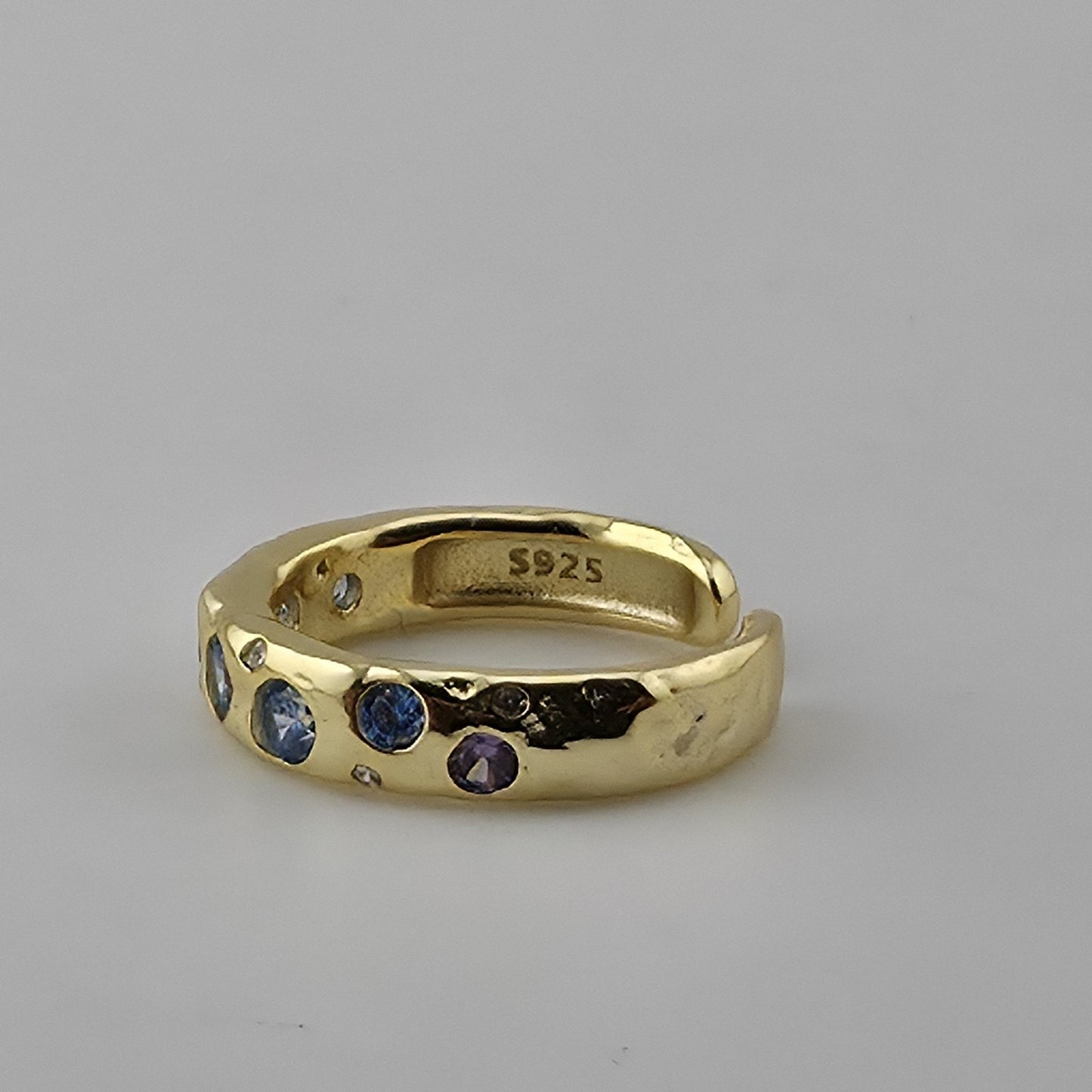 Colorful gold plated sterling silver ring on white background